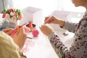 Young girls in knitting workshop