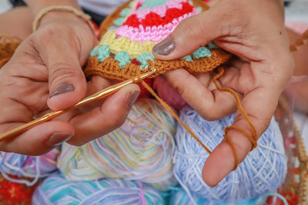 person knitting a creation